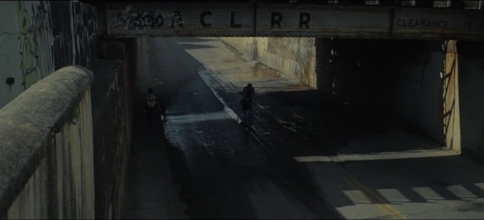 corey riding under bridge